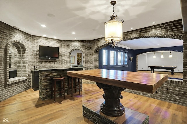 interior space featuring light wood-style floors, arched walkways, recessed lighting, and pool table