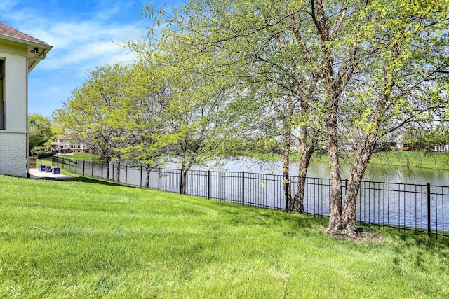 view of yard with fence and a water view