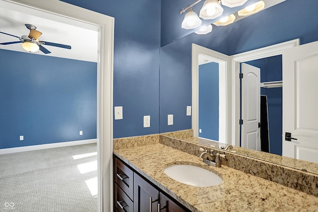 bathroom featuring vanity, baseboards, and a ceiling fan
