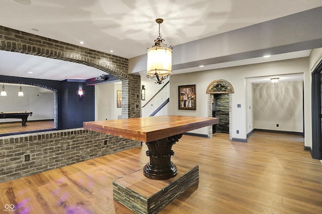 game room with billiards, decorative columns, arched walkways, wood finished floors, and recessed lighting