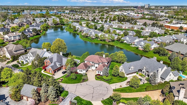 drone / aerial view featuring a water view and a residential view