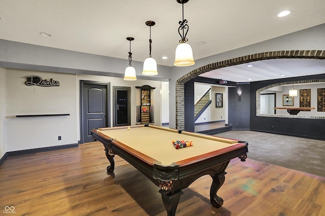rec room featuring arched walkways, recessed lighting, wood finished floors, and pool table