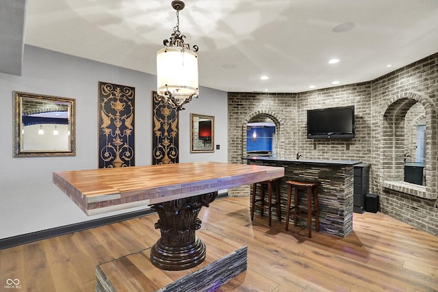 bar with recessed lighting, hanging light fixtures, and wood finished floors