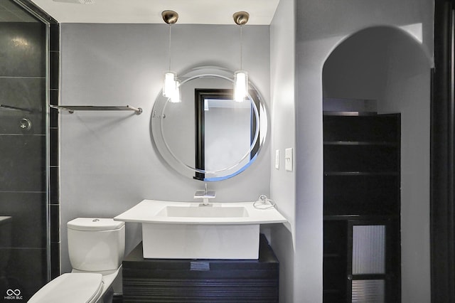 bathroom with toilet and a sink
