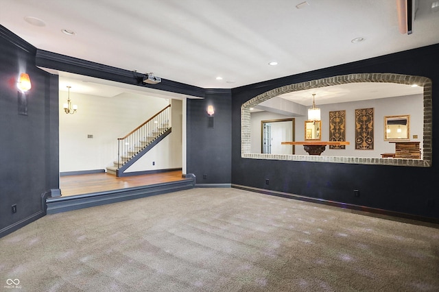 spare room featuring crown molding, carpet, stairs, recessed lighting, and baseboards