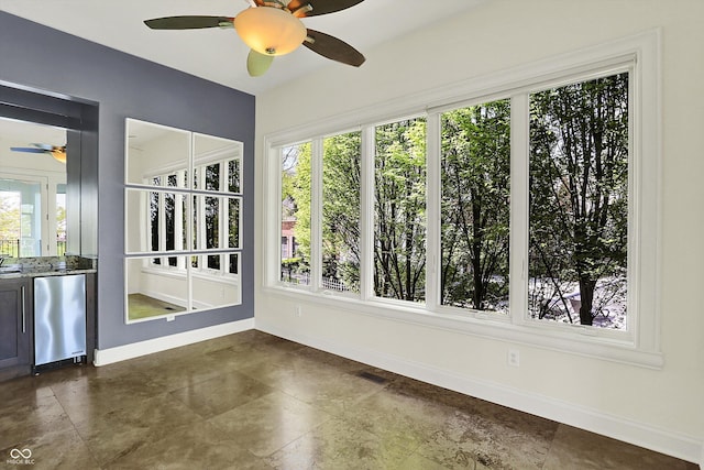 unfurnished sunroom with baseboards