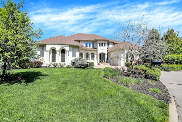 mediterranean / spanish-style home featuring stucco siding and a front yard
