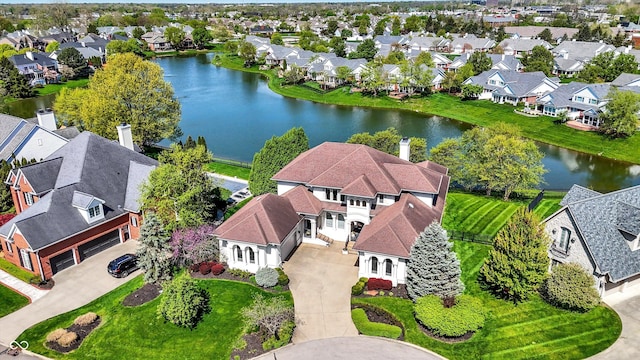 drone / aerial view featuring a residential view and a water view