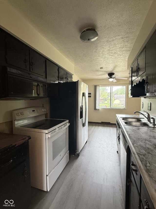 645 Boulder Rd, Indianapolis, IN 46217 - kitchen with a ceiling fan, white electric stove, a textured ceiling, black microwave, and a sink