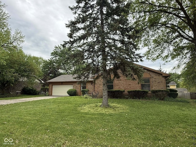 645 Boulder Rd, Indianapolis, IN 46217 - view of front of house featuring driveway, a front yard, brick siding, fence, and an attached garage