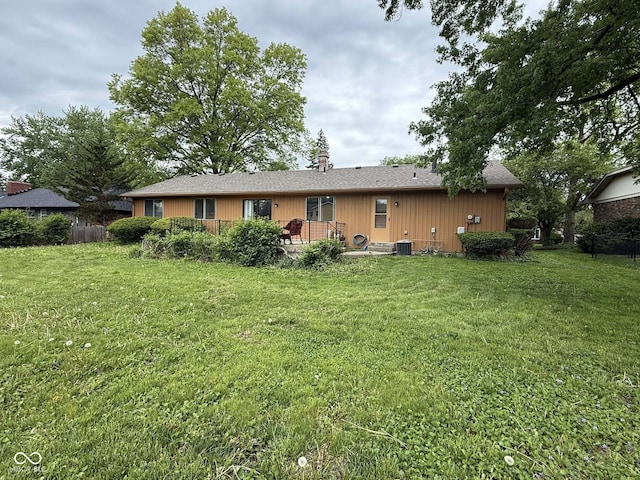 645 Boulder Rd, Indianapolis, IN 46217 - rear view of house with a lawn, central AC, fence, and a wooden deck