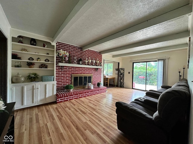 645 Boulder Rd, Indianapolis, IN 46217 - living area with a textured ceiling, beam ceiling, wood finished floors, and a fireplace