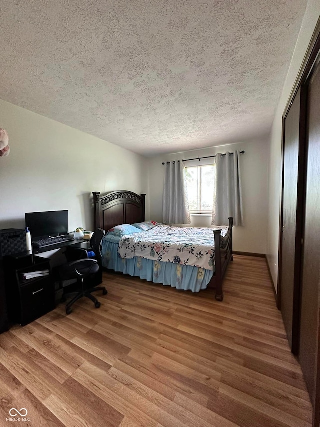 645 Boulder Rd, Indianapolis, IN 46217 - bedroom with a textured ceiling and wood finished floors