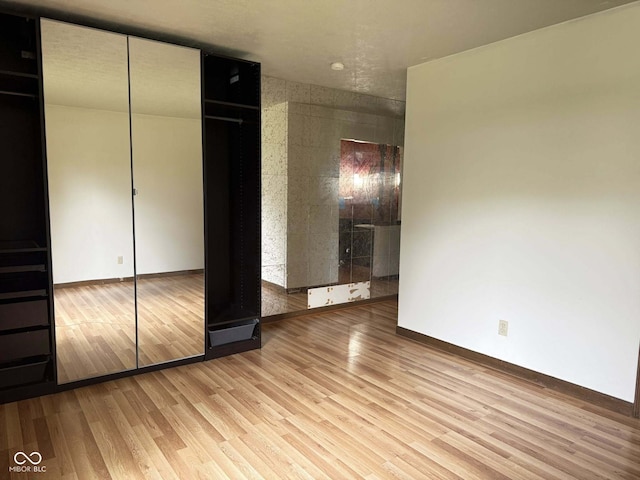 645 Boulder Rd, Indianapolis, IN 46217 - unfurnished bedroom with light wood-style floors and baseboards