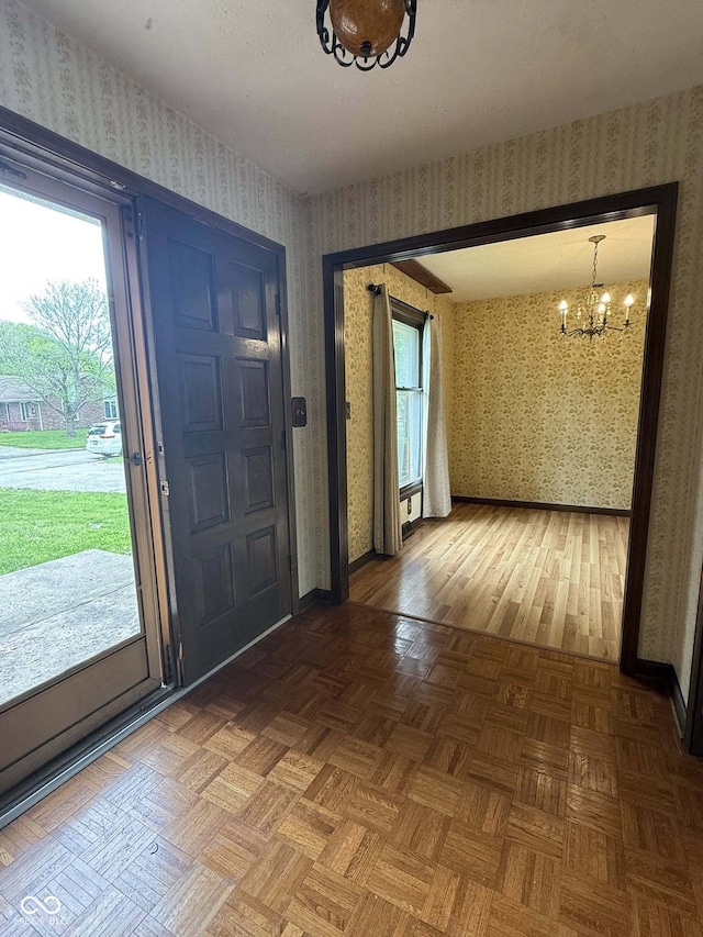 645 Boulder Rd, Indianapolis, IN 46217 - entrance foyer with wallpapered walls, a chandelier, and baseboards