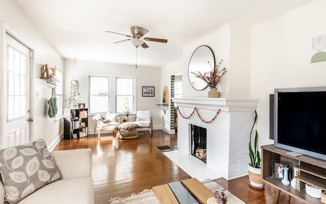 4406 Carrollton Ave, Indianapolis, IN 46205 - living room featuring ceiling fan, wood finished floors, and a brick fireplace