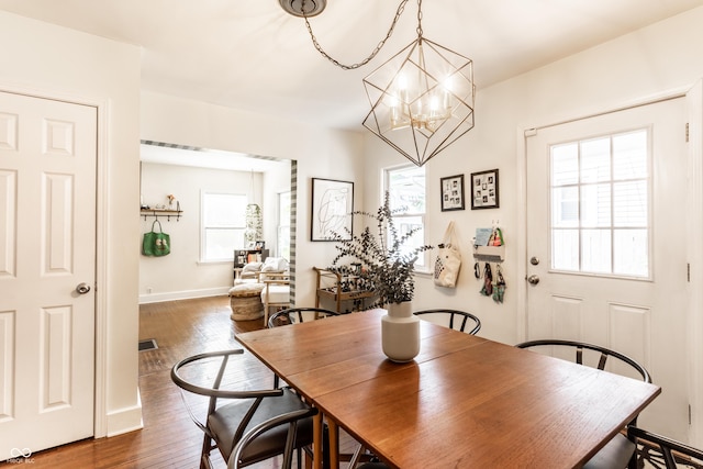 4406 Carrollton Ave, Indianapolis, IN 46205 - dining room with a chandelier and dark wood-style flooring