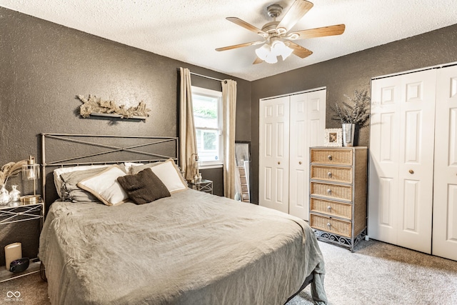 4406 Carrollton Ave, Indianapolis, IN 46205 - carpeted bedroom featuring a textured wall, multiple closets, a textured ceiling, and ceiling fan