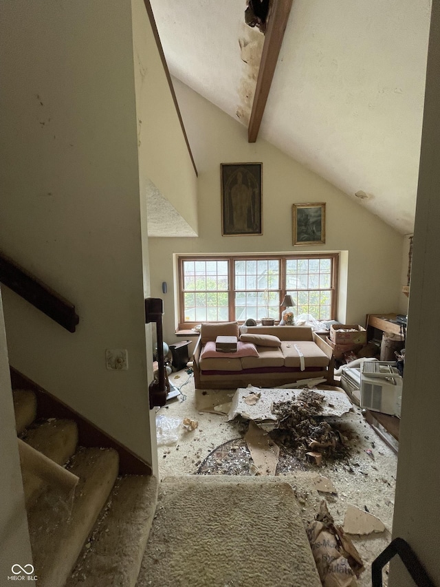 living room with lofted ceiling with beams
