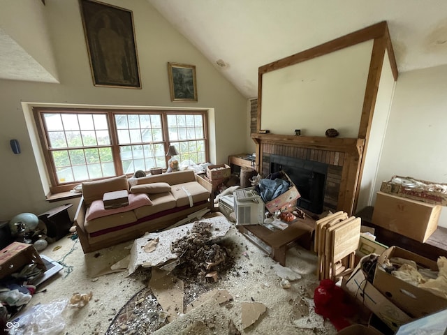 living room with vaulted ceiling and a fireplace