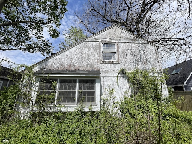 view of home's exterior with fence