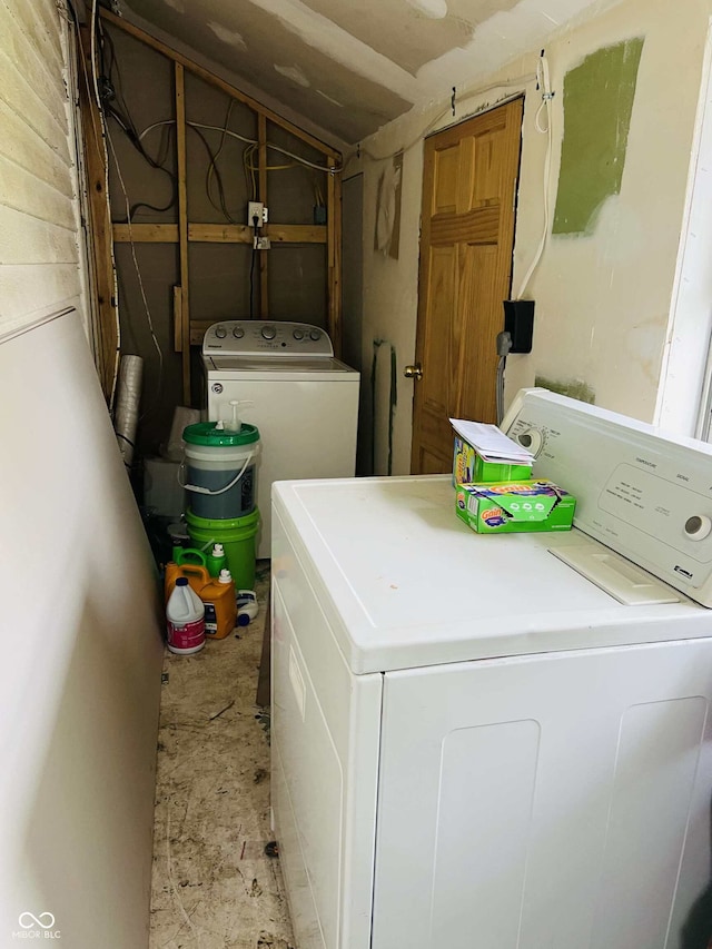 clothes washing area featuring laundry area and washer and dryer