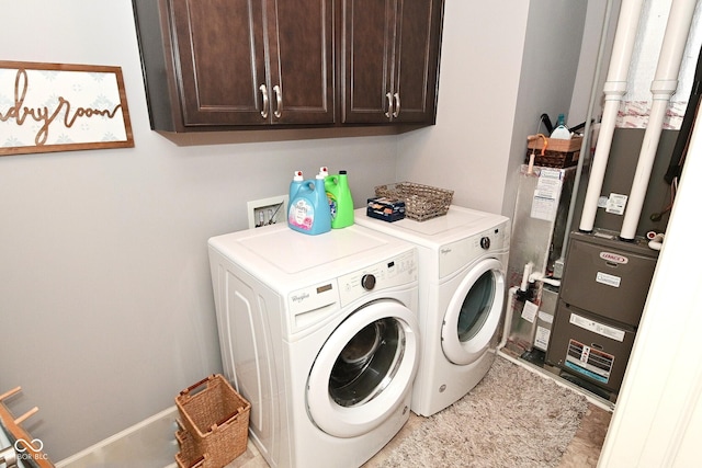 laundry room featuring separate washer and dryer and cabinet space