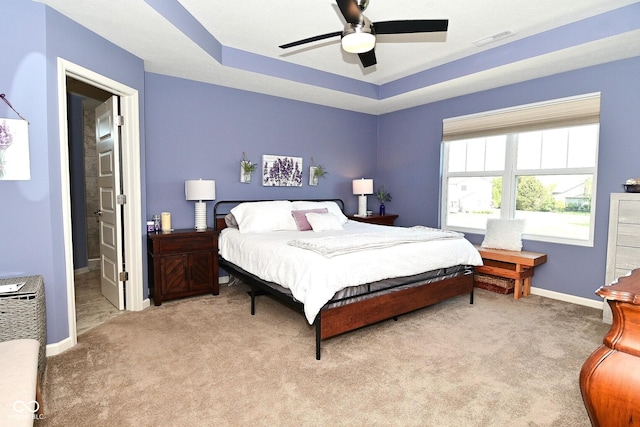bedroom with a ceiling fan, baseboards, visible vents, and light carpet