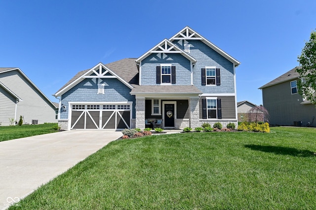 craftsman house with an attached garage, driveway, stone siding, and a front lawn