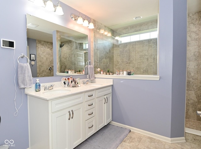 full bathroom featuring double vanity, a sink, a walk in shower, and tile patterned flooring