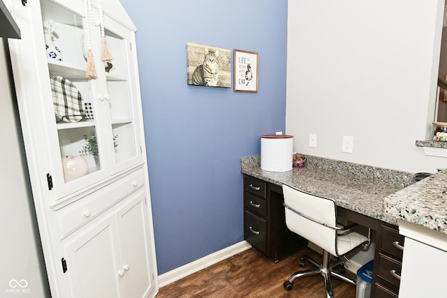 office space featuring built in study area, baseboards, and dark wood finished floors