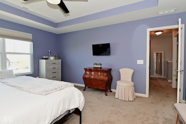 bedroom featuring visible vents, baseboards, ceiling fan, and light carpet