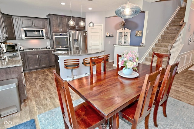 dining room with recessed lighting, dark wood finished floors, stairway, and a toaster