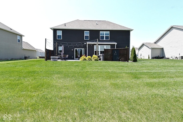 rear view of property featuring central AC unit, a yard, and a patio area