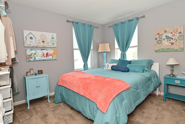 bedroom with carpet floors and baseboards
