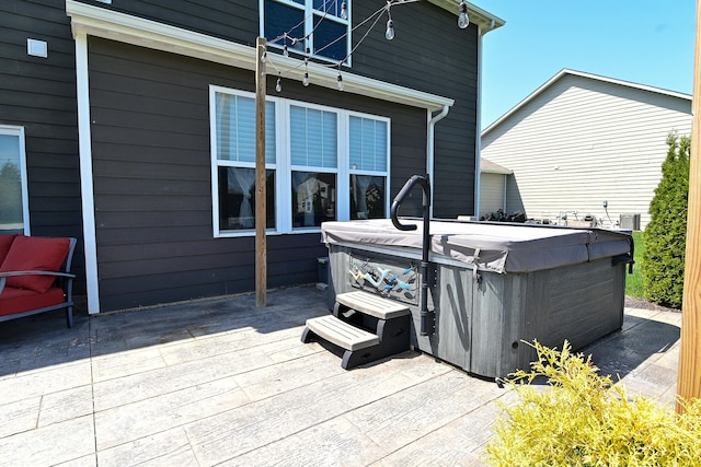wooden deck with a hot tub
