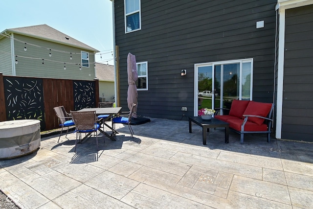 view of patio featuring fence and outdoor dining area