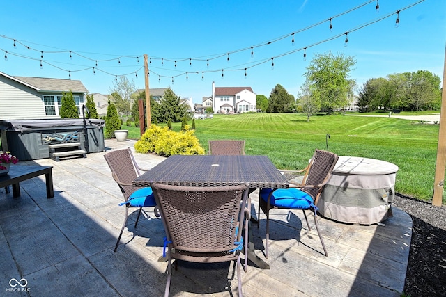 view of patio with outdoor dining area and a hot tub