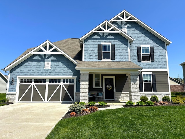 craftsman house with driveway, a porch, a front lawn, and stone siding
