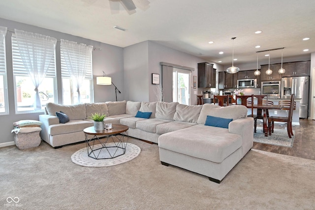 living room featuring recessed lighting, ceiling fan, visible vents, and baseboards