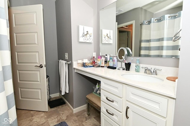 full bathroom featuring vanity, baseboards, and a shower with shower curtain