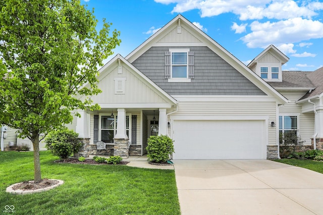 6241 Colonial Dr, Whitestown, IN 46075 - craftsman inspired home with stone siding, a porch, a front yard, driveway, and a garage