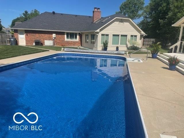 view of pool with a fenced in pool, fence, and a patio