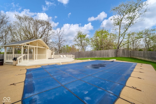 view of pool with a fenced in pool, a fenced backyard, a diving board, and a patio area