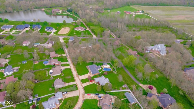 drone / aerial view with a water view and a residential view