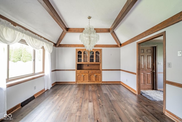 unfurnished dining area with baseboards, lofted ceiling with beams, a chandelier, and dark wood-style floors