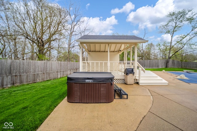 view of patio / terrace featuring a fenced backyard and a hot tub