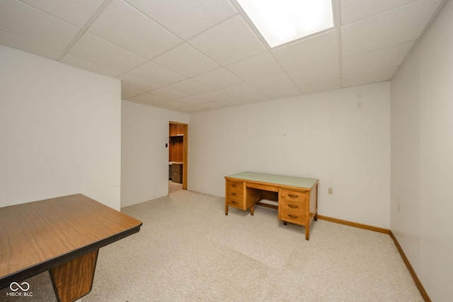 interior space with carpet floors and a paneled ceiling