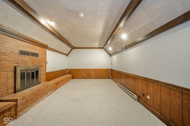 bonus room featuring wooden walls, baseboard heating, carpet, and a wainscoted wall