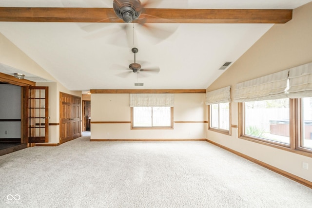 spare room with visible vents, carpet flooring, baseboards, ceiling fan, and lofted ceiling with beams
